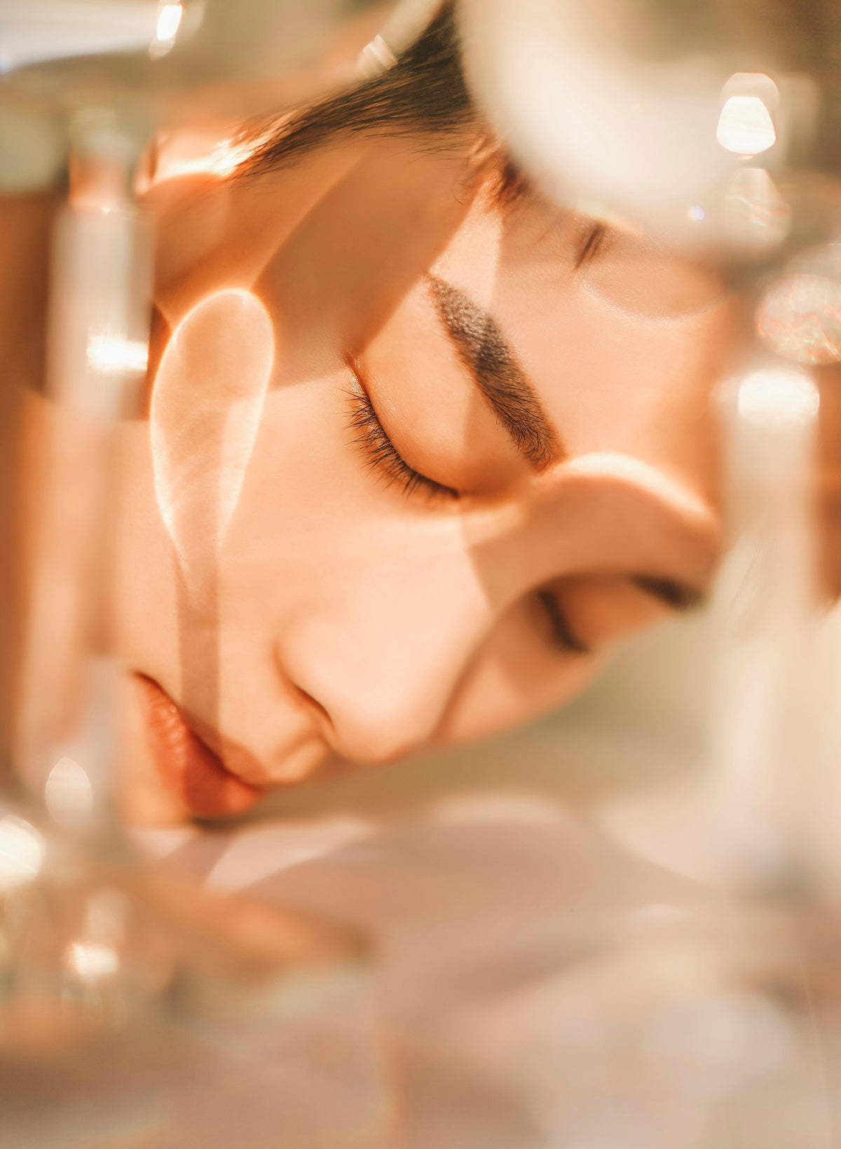 Woman with closed eyes behind glass reflections